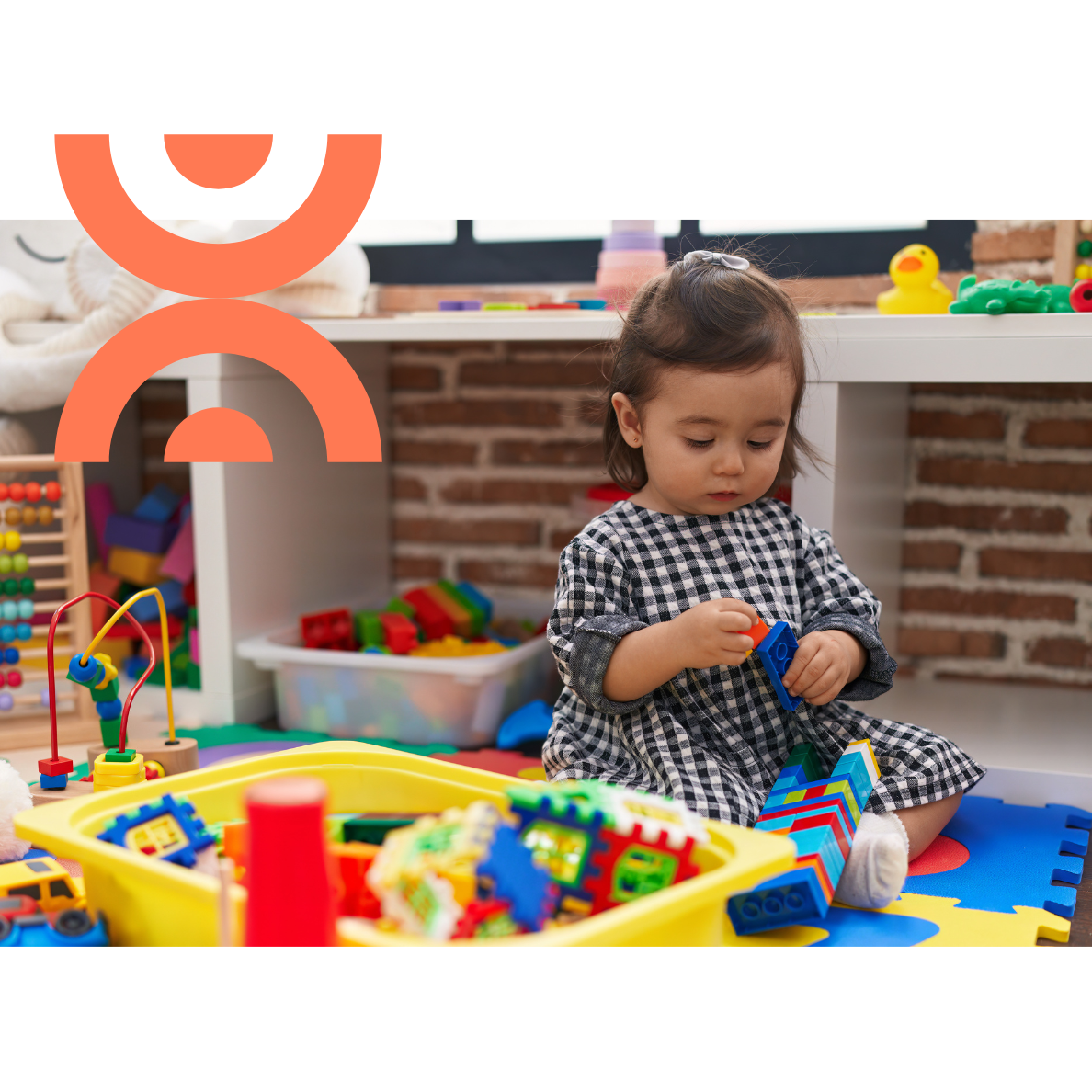 A young child engaging in hands-on play therapy with construction blocks at a Liverpool behaviour therapy clinic, improving focus and fine motor skills.