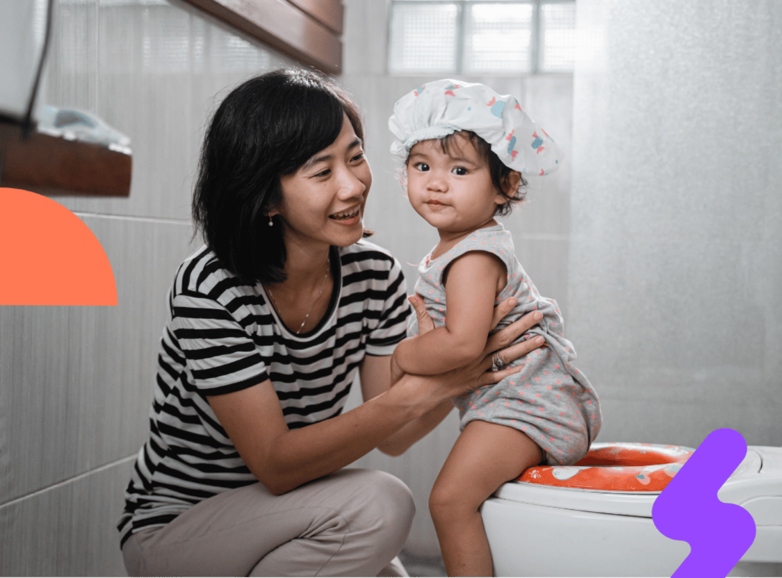 Mum supporting her child during a toileting training routine.