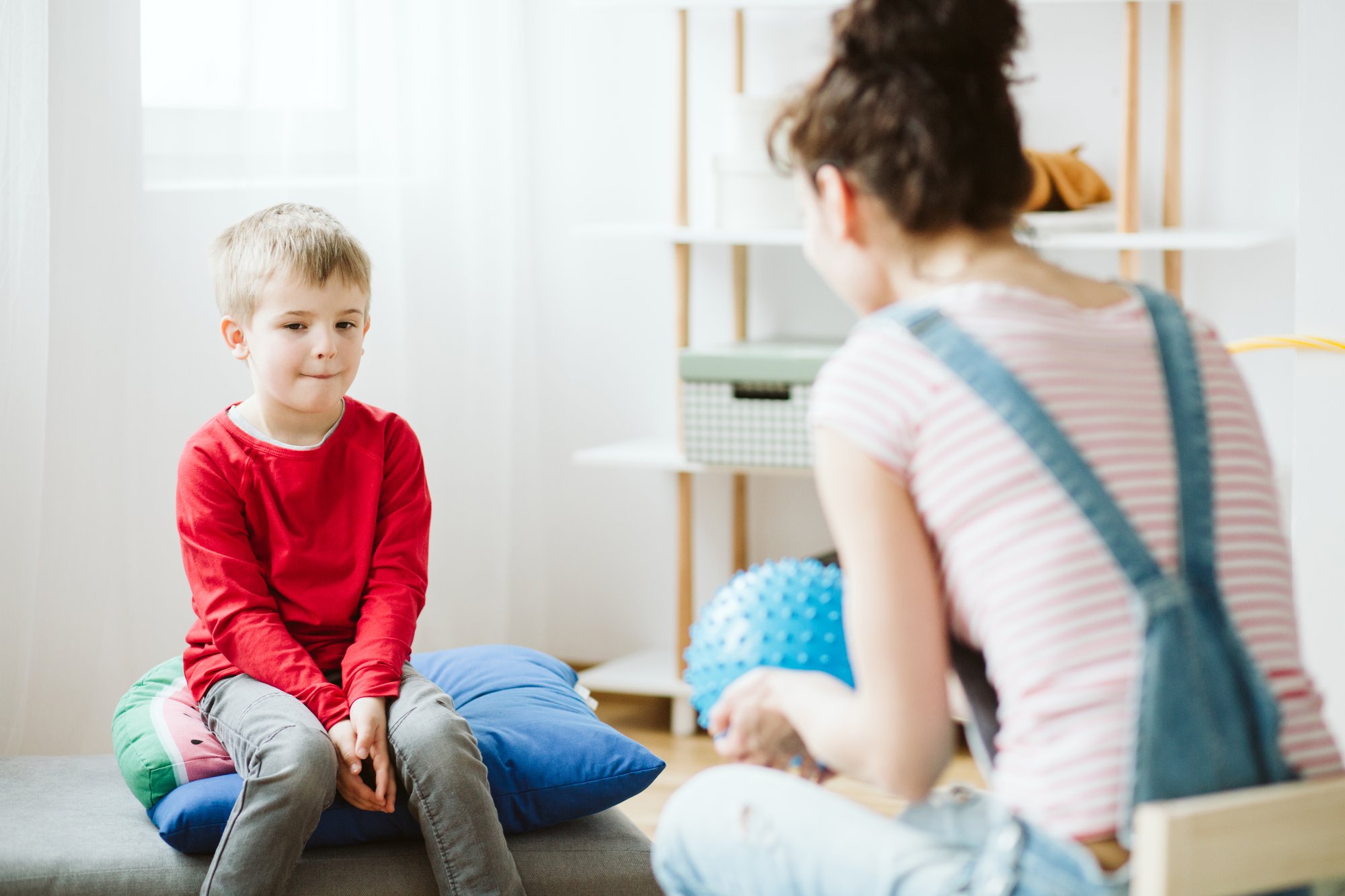 A therapist and a child in a comprehensive behaviour therapy session.