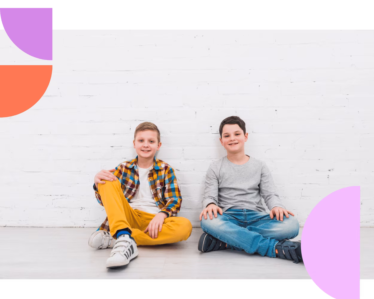 Two young children sitting together during a behaviour support session