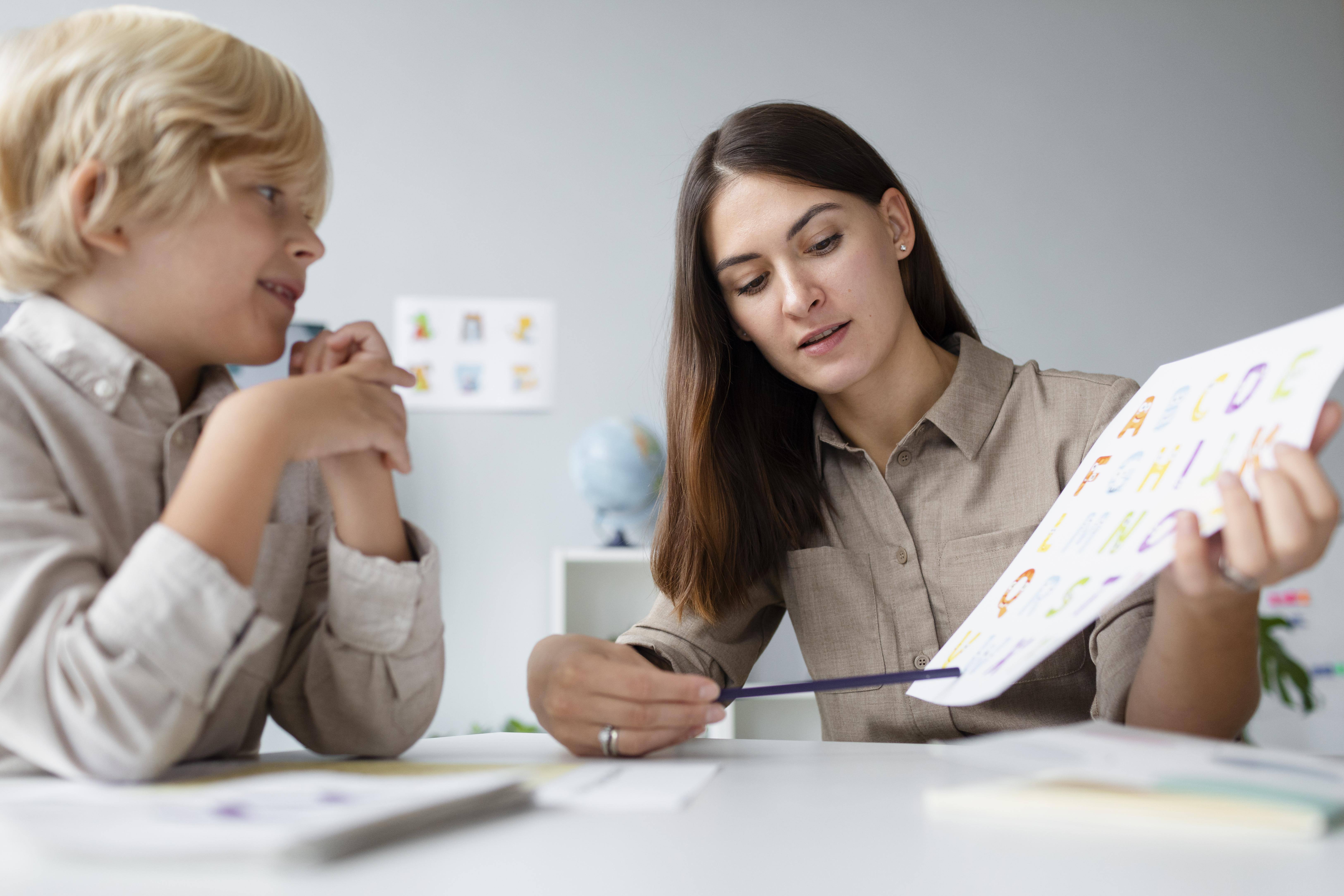 woman-doing-speech-therapy-with-little-blonde-boy