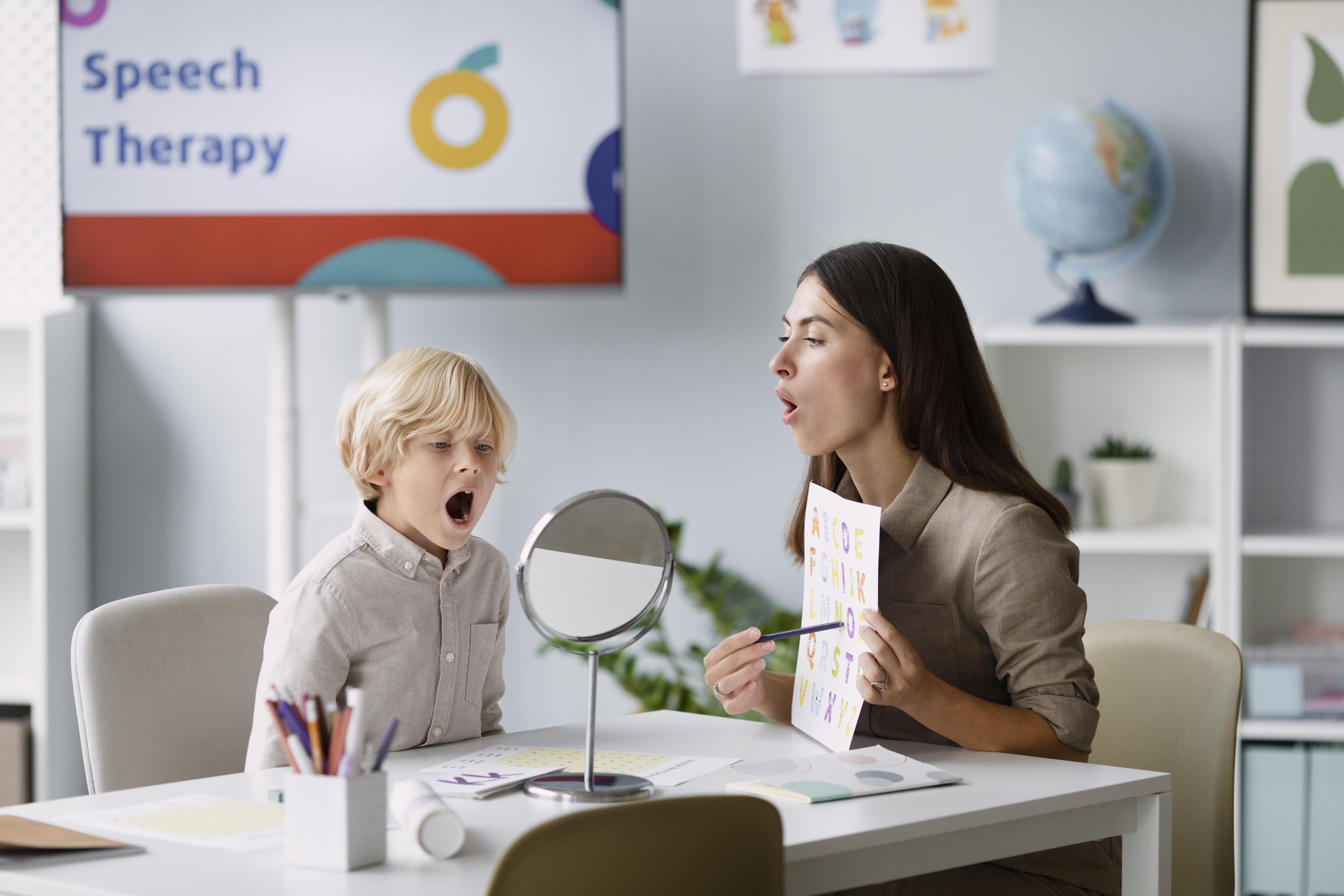 woman-doing-speech-therapy-with-little-boy-her-clinic
